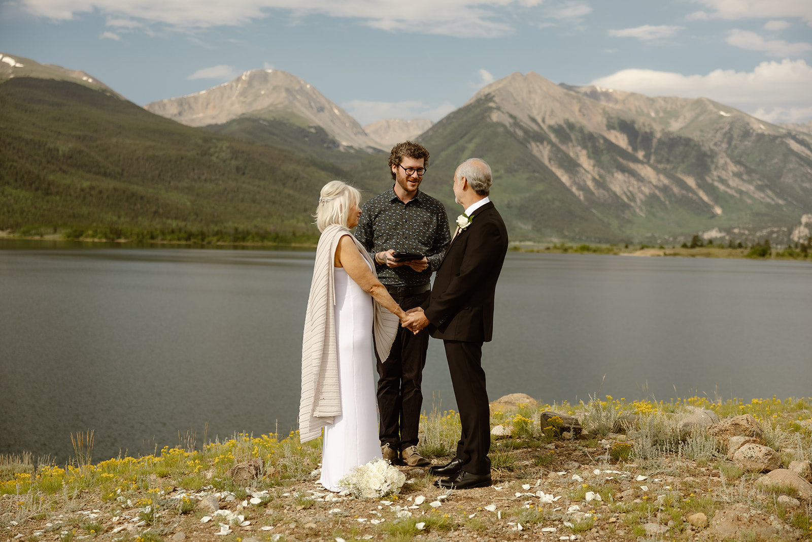 A bride and groom holding hands during their elopement ceremony near Aspen Colorado.