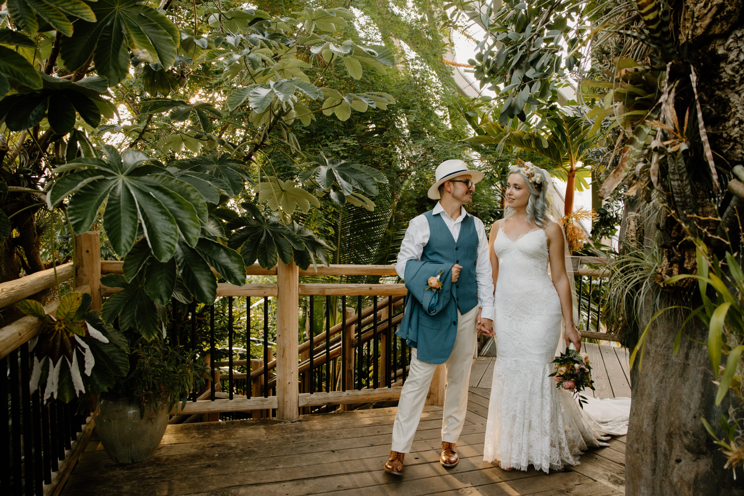 One of the best places to elope in Colorado, Denver Botanic Gardens, has plenty of amazing locations for photos. Like their greenhouse, pictured here with a bride and groom.