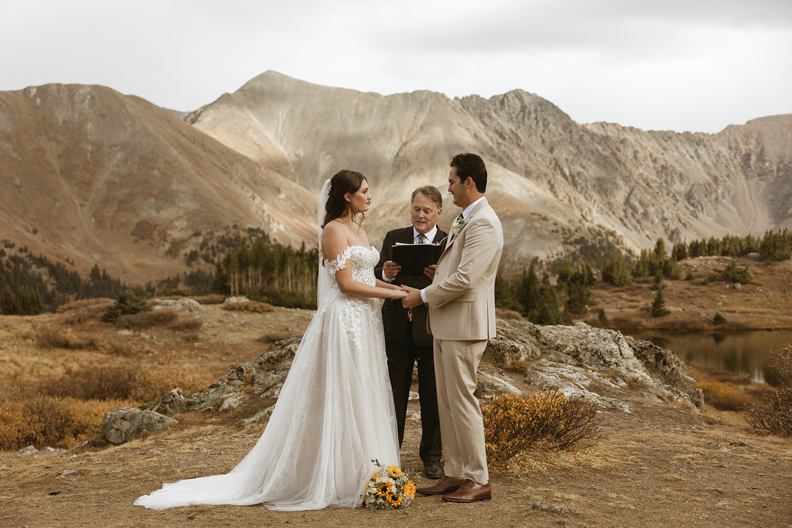 A bride and groom exchange vows at Loveland Pass Colorado.
