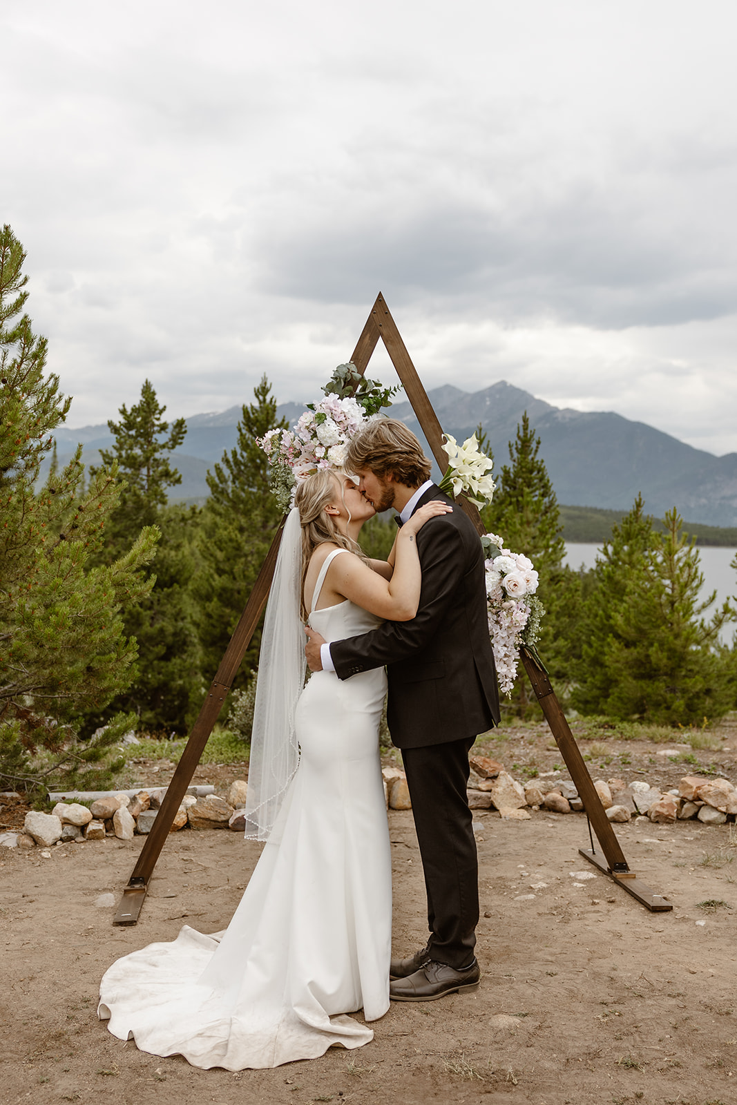 A bride and groom share their first kiss at one of the best Breckenridge elopement locations. 