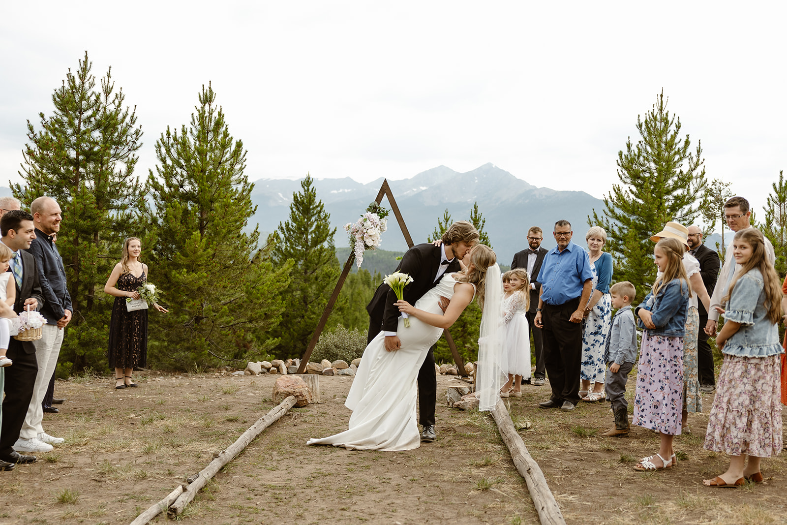 A bride and groom share their first kiss at one of the best places to elope in Colorado.