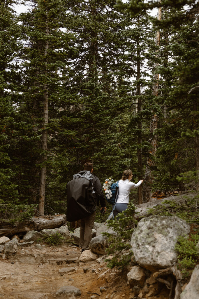 bride and groom hiking to Lake Isabelle in Colorado