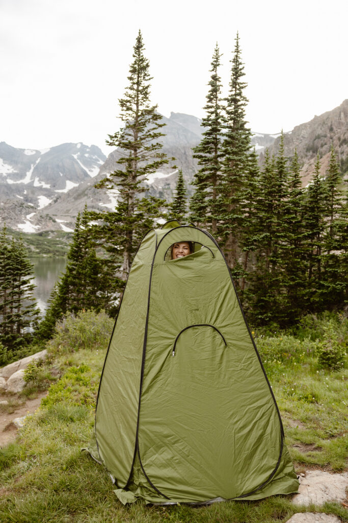 bride getting ready in pop up tent at Lake Isabelle in Colorado